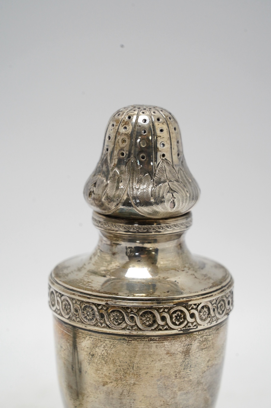 An Edwardian silver miniature model of a tripod table with piecrust border, Goldsmiths & Silversmiths Co Ltd, Sheffield, 1908, diameter 11.1cm, together with a French 950 standard white metal sugar caster, 7.3oz. Conditi